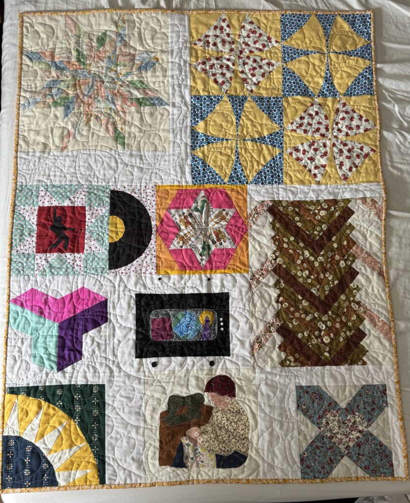Finished quilt; descriptions of each block appear in the blog post.