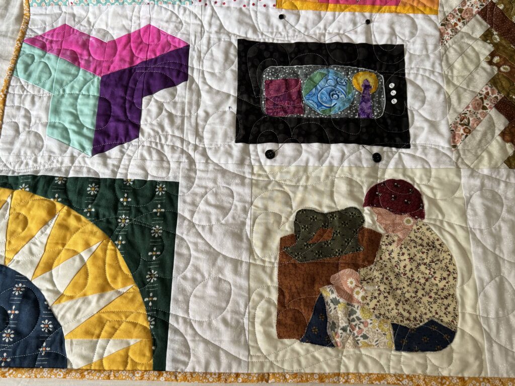 Detail of the appliqué block featuring my grandmother at her sewing machine.
